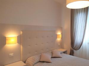 a bedroom with a bed with two pillows on it at Albergo Degli Amici in Monterosso al Mare
