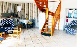 a living room with a staircase and a dining room at Maison de La Beslière meublé de tourisme 2 étoiles in Folligny +43 photos