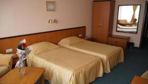 a hotel room with two beds and a table at Troyan Plaza Hotel in Troyan +85 photos