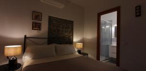 a bedroom with a bed with two lamps and a window at Arbanella in Corniglia