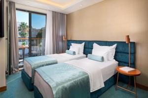 Ліжко або ліжка в номері Time Boutique Hotel
