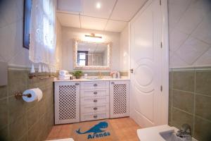 a bathroom with a sink and a mirror at Arenda Villa Rosa in Hospitalet de l'Infant