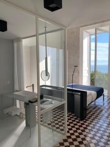 a bedroom with a bed and a sink and a mirror at PrimoPianoPosillipo in Naples