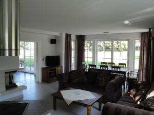 a living room with a couch and a table at Ostsee Strandvilla Silvia in Lobbe