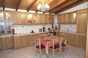 a kitchen with wooden cabinets and a table with chairs at Gramvoussa Bay in Kissamos