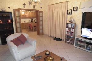 a living room with a couch and a tv and a table at Gramvoussa Bay in Kissamos