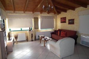 a living room with a couch and a table at Gramvoussa Bay in Kissamos