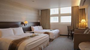 En eller flere senge i et værelse på Ho Fong Business Stay