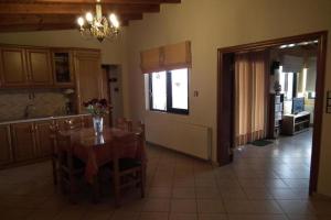 a kitchen and dining room with a table and chairs at Gramvoussa Bay in Kissamos