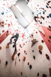 a person on a climbing wall in a climbing gym at Hotel Samerhof - Badestrand inklusive in Tröpolach +225 photos