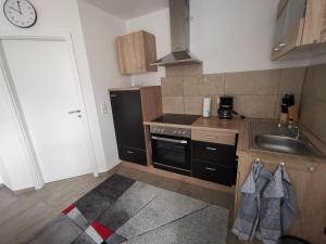 a small kitchen with a sink and a stove at Kinderlachen in Wasserburg am Bodensee