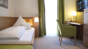 Säng eller sängar i ett rum på Hotel Germania