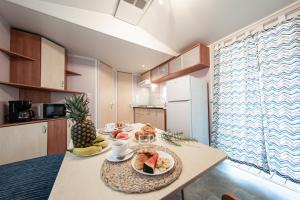 a kitchen with a table with fruit on it at Albatross Mobile Homes on Camping Playa Brava in Pals