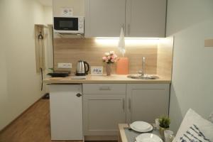 a small kitchen with a sink and a microwave at Серафимовича 1 дробь 4-33-1 in Novosibirsk