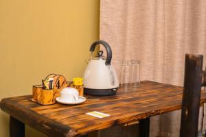 a tea kettle on top of a wooden table at Burka Coffee Lounge in Arusha