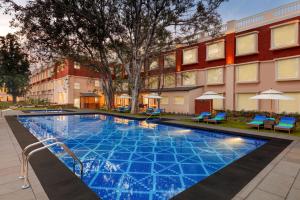 a swimming pool in front of a building at Welcomhotel by ITC Hotels, Raja Sansi, Amritsar in Amritsar