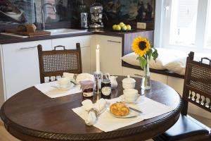 a dining room table with a table set with food and candles at Der Westflügel Admiralssuite WF-46 in Stolpe auf Usedom