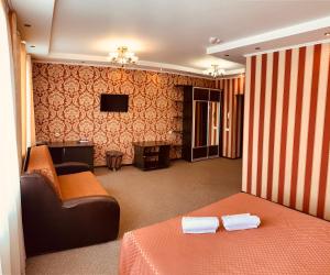 a hotel room with a bed and a television at Krokus Hotel in Omsk