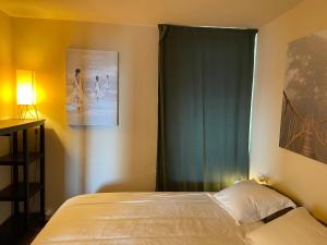 a bedroom with a bed and a green curtain at BLANES PORT BAY VIEW in Blanes