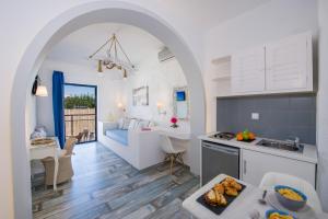 a kitchen and living room with an open archway at Seagull Hotel and Apartments in Agia Marina Nea Kydonias