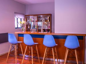 a row of chairs sitting in front of a bar at Flag Hotel Braga in Braga