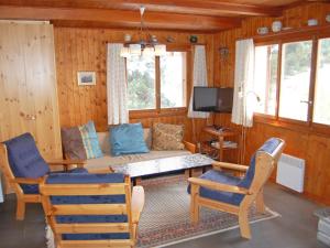 a living room with a couch and chairs and a tv at Chalet Mungg by Interhome in Nendaz
