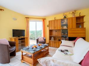 a living room with a couch and a coffee table at Villa Orée des Salines by Interhome in Le Grau-du-Roi