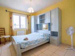 a bedroom with a bed and a cabinet and a window at Villa Orée des Salines by Interhome in Le Grau-du-Roi