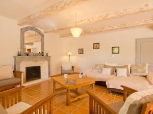 a living room with a couch and a table at Holiday Home L'Olivier by Interhome in Lagnes