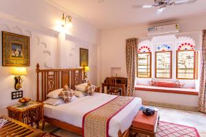 a bedroom with a large bed in a room at Amet Haveli in Udaipur