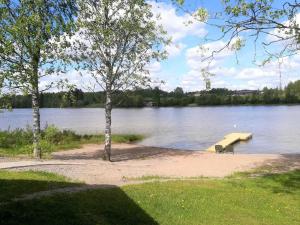 a dock on a lake with a boat in the water at Holiday Home Peltosirkku by Interhome in Hirsjärvi