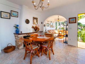 a dining room with a table and chairs and a fireplace at Holiday Home Meluca by Interhome in Calpe