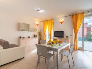a dining room and living room with a table and chairs at Apartment Riva Mare by Interhome in Riva Ligure