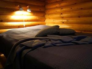 KinnulaにあるHoliday Home Metsä-pihlaja by Interhomeの木製の壁のベッドルーム1室(ベッド1台付)