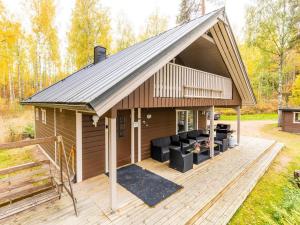 a house with a pitched roof with a deck at Holiday Home Ranta 3 by Interhome in Vääksy +34 photos