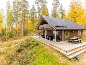 a cabin in the woods with a wooden deck at Holiday Home Ranta 3 by Interhome in Vääksy