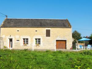 an old stone house with a table and chairs at Holiday Home Le Clos Renard by Interhome in Commes