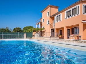 a swimming pool in front of a house at Holiday Home Ulika by Interhome in Golaš