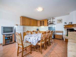 a kitchen and dining room with a table and chairs at Holiday Home Ulika by Interhome in Golaš