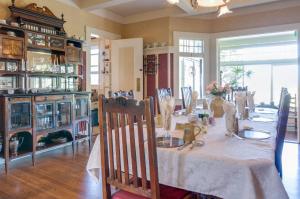 a dining room with a table with a white table cloth at The Jabberwock Bed & Breakfast in Monterey