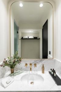 a white bath tub sitting next to a white sink at Villa Brown Ermou Hotel, a member of Brown Hotels in Athens