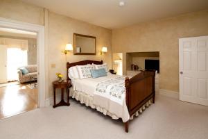 a bedroom with a bed and a living room at Captain Farris House in South Yarmouth