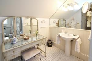 a bathroom with a sink and a mirror at Captain Farris House in South Yarmouth