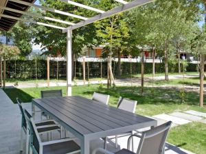 a picnic table and chairs under a pergola at Holiday Home Fior di Sole by Interhome in Manerba del Garda