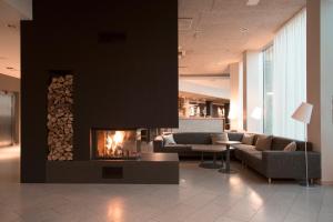 a living room filled with furniture and a fire place at Georg Ots Spa Hotel in Kuressaare