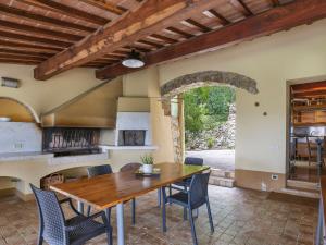 a kitchen and dining room with a wooden table and chairs at Holiday Home Maestraccio by Interhome in Buti