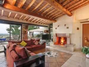 a living room with a couch and a fireplace at Holiday Home Maestraccio by Interhome in Buti