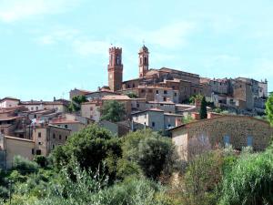 a group of buildings on a hill with two towers at Holiday Home Podere Casina by Interhome in Sinalunga