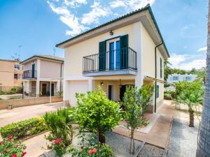a house with a balcony and some plants at Holiday Home Les Savines by Interhome in Alcudia