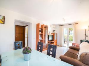 a living room with a table and a couch at Holiday Home Les Savines by Interhome in Alcudia